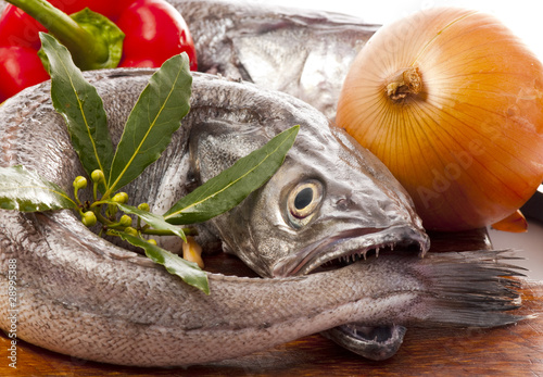 Fotografie Young hake fish being prepared for cooking with a variety of veg
