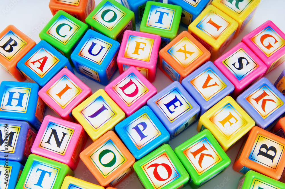 Learning and education concept - pile of alphabet blocks Learning and education concept - pile of alphabet blocks