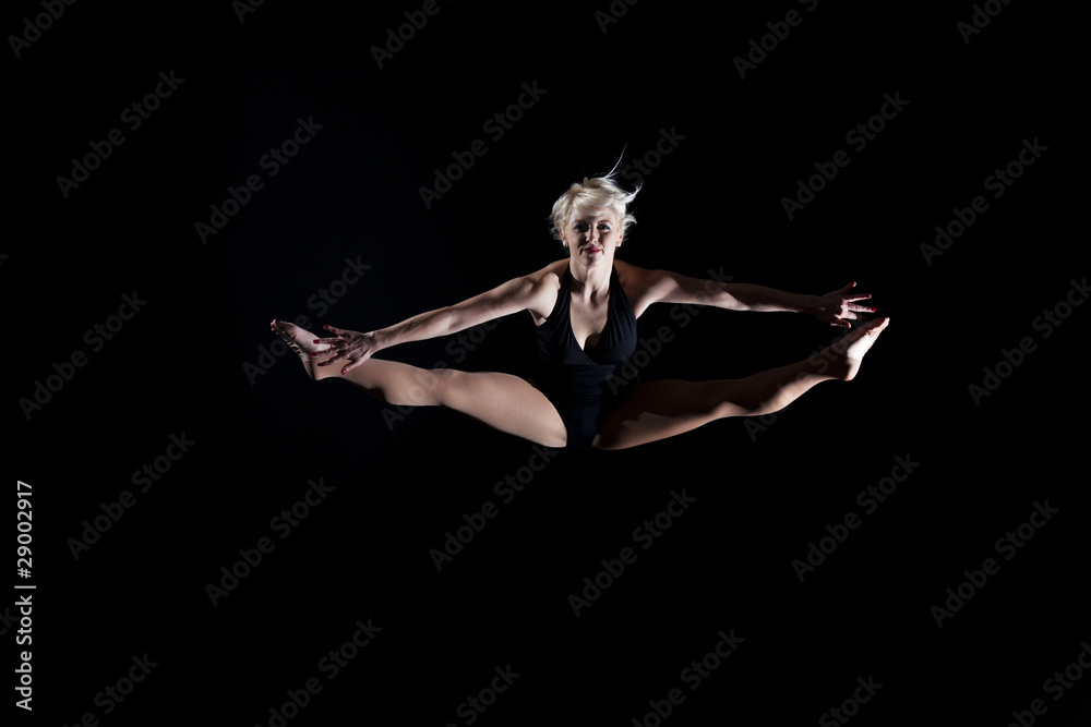 Girl performing the splits in the air Girl performing the splits in the air