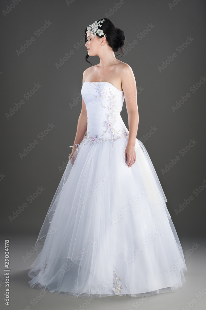 pretty young bride wearing traditional white wedding gown pretty young bride wearing traditional white wedding gown