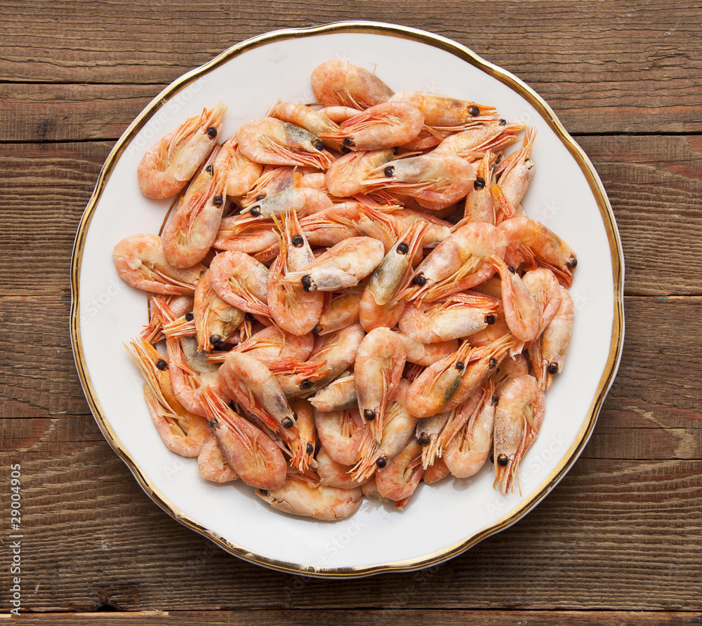 closeup of plate of shrimp on wood background closeup of plate of shrimp on wood background