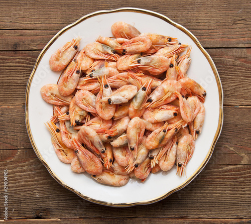 closeup of plate of shrimp on wood background