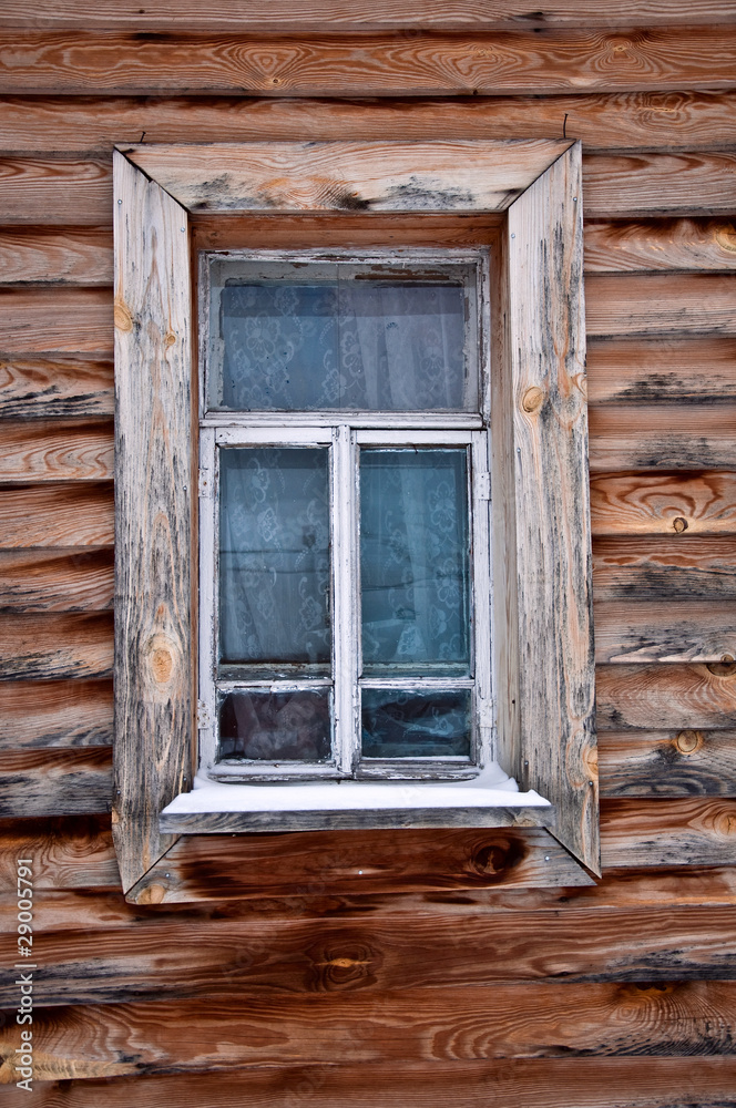 Old rustic wall with a window. Fragment. Rural life.