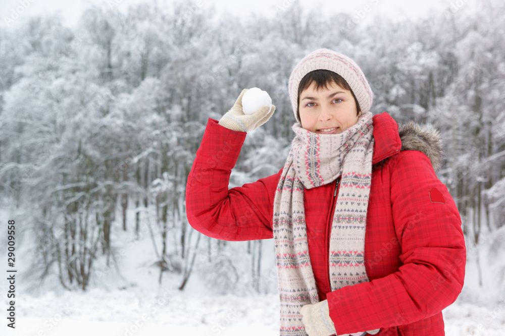 Young woman with snow ball in winter forest Young woman with snow ball in winter forest
