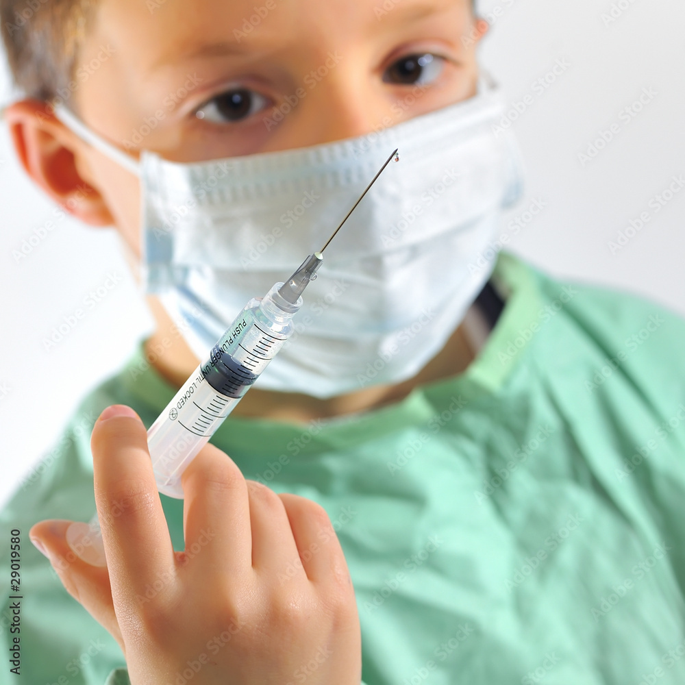 a little boy in a doctors uniform