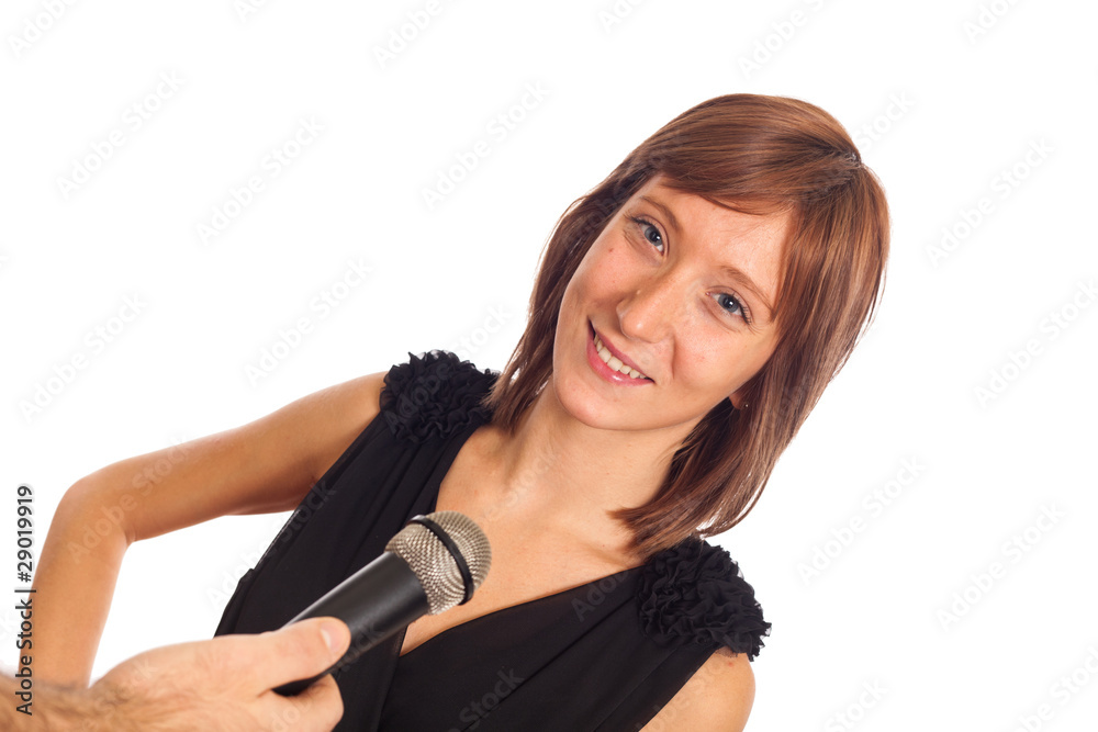 Young Woman Talking on the Microphone during Interview Young Woman Talking on the Microphone during Interview