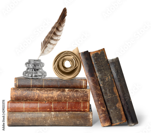 Isolated books. Stack of old books, inkstand with quill and scroll isolated on white background photo