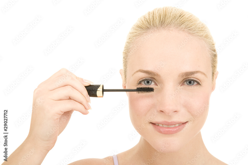 Woman applying mascara