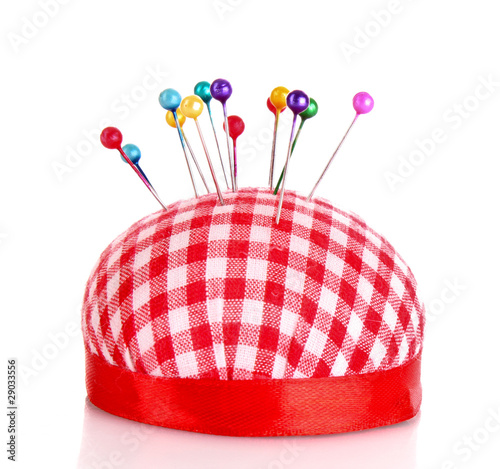 Colored pinheads in pin-cushion isolated on white