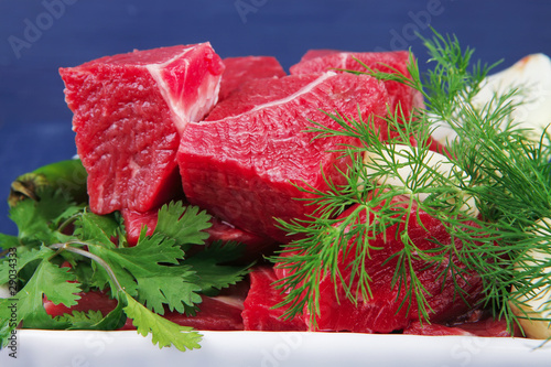 fresh uncooked beef meat slices over white bowls