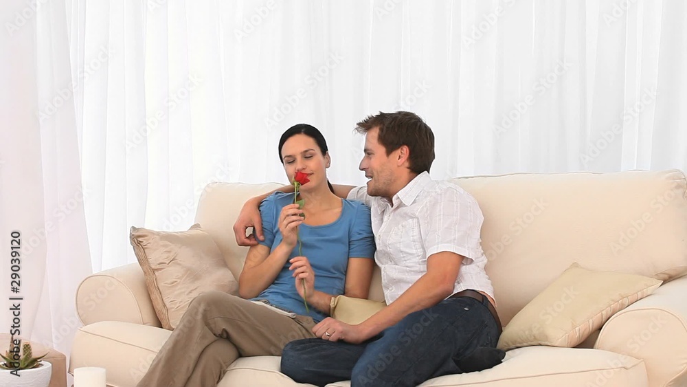 Lovely woman happy whith her rose that her boyfriend offered her Lovely woman happy whith her rose that her boyfriend offered her
