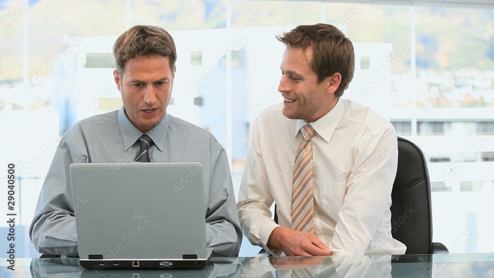 Businessmen working together in a office Businessmen working together in a office