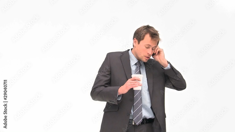Businessman phoning while he is drinking coffee Businessman phoning while he is drinking coffee