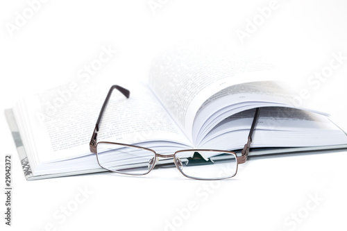 glasses on an open book
