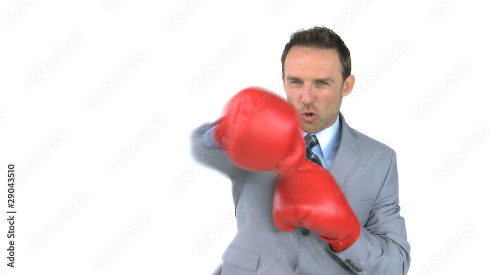 Happy man giving punches with boxing gloves Happy man giving punches with boxing gloves