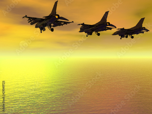 Three F-16 Fighter Jets over the ocean