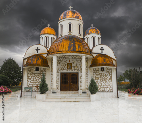 Orthodox church with copper roof and thunder storm