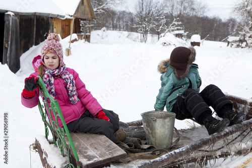 Russian, rural the boy and girl  on sledge in the winter photo