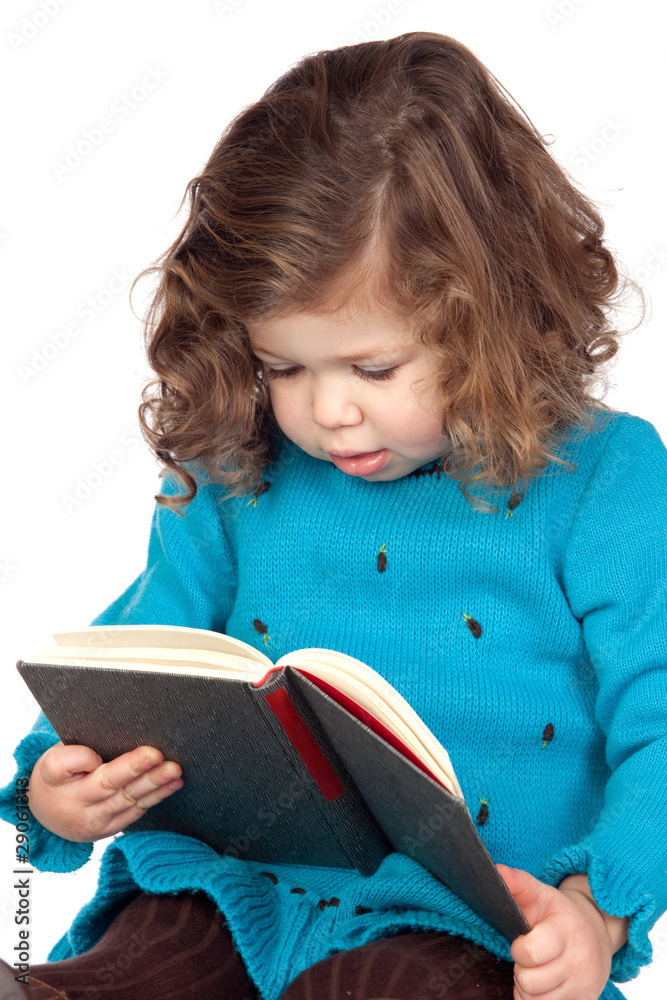 Smiling baby girl reading a book