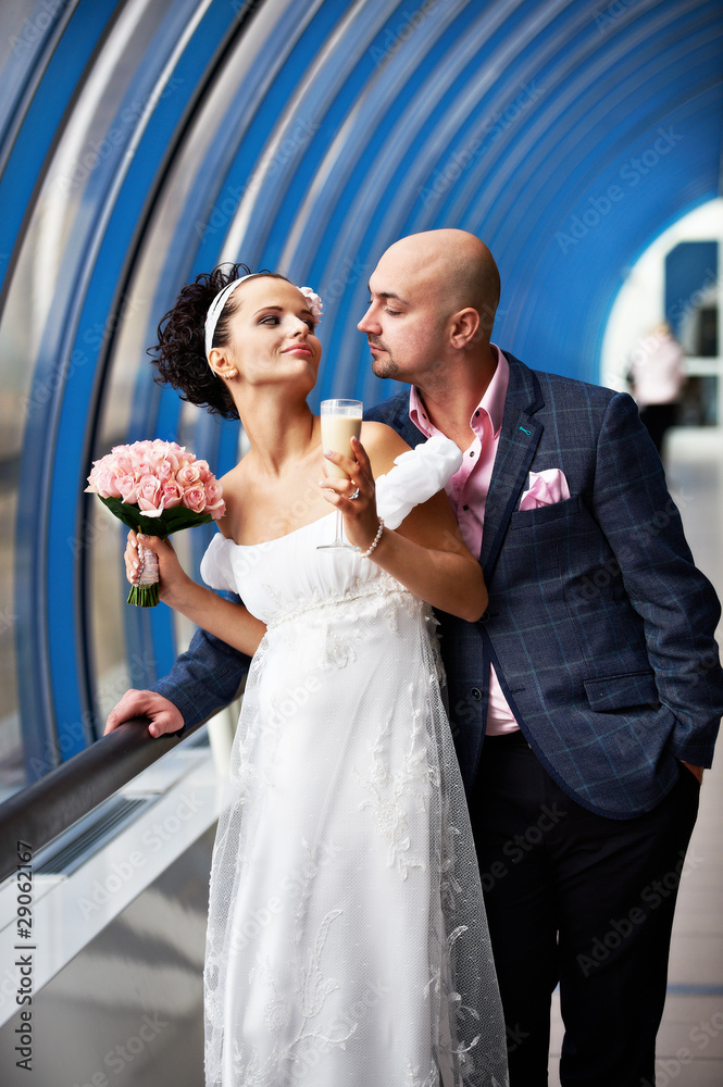 Bride and groom in blue interior Bride and groom in blue interior