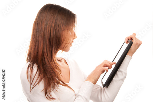 Woman typing on electronic tablet touch pad