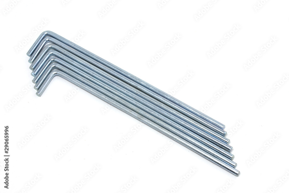 Seven round metal tent pegs on white background