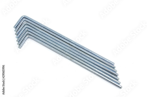 Seven round metal tent pegs on white background