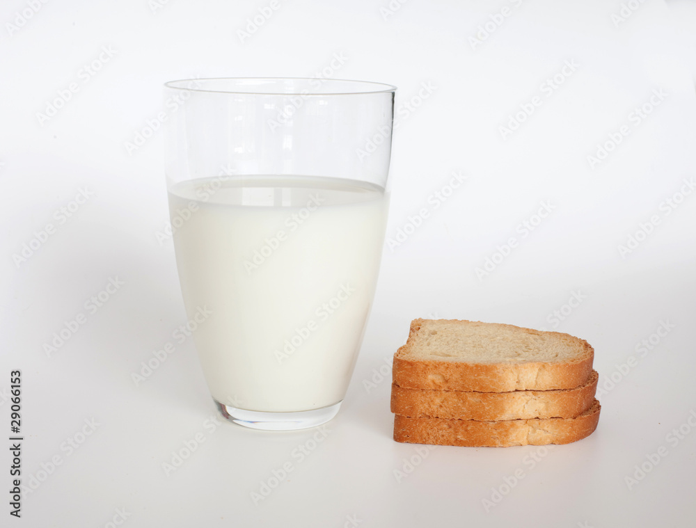 pieces of dried bread and glass of milk pieces of dried bread and glass of milk