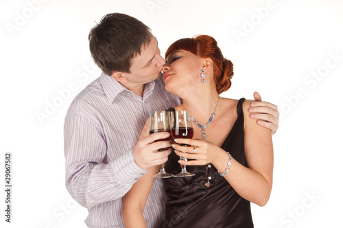Young loving couple with red wine glasses in hands