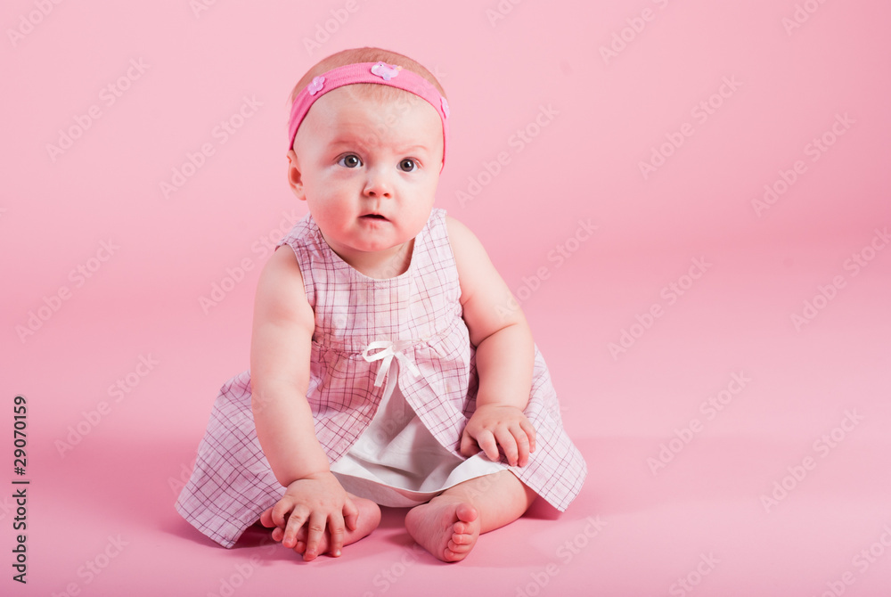Portrait of the surprised girl on a pink background