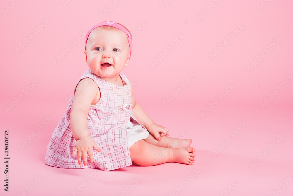 Portrait of the small beautiful joyful girl on a pink background Portrait of the small beautiful joyful girl on a pink background