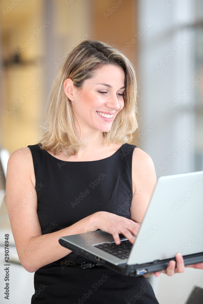 Smiling businesswoman usin laptop computer Smiling businesswoman usin laptop computer