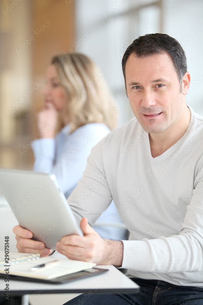 Office worker in the office using electronic tab Office worker in the office using electronic tab