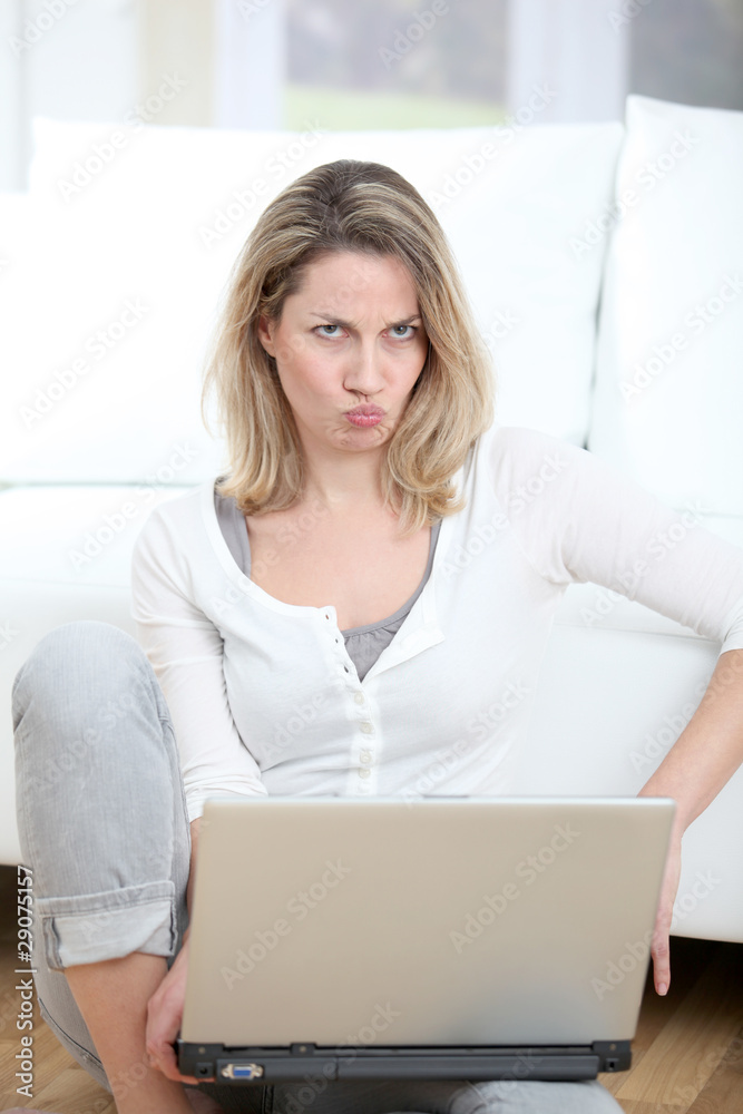 Woman with mad look using laptop computer