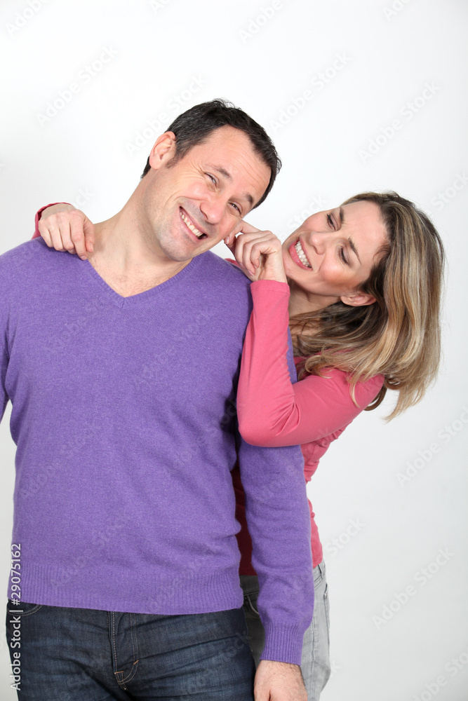 Woman pulling on her boyfriend's cheek
