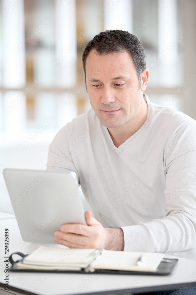 Office worker in the office using electronic tab Office worker in the office using electronic tab