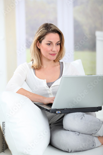 Woman using laptop computer at home