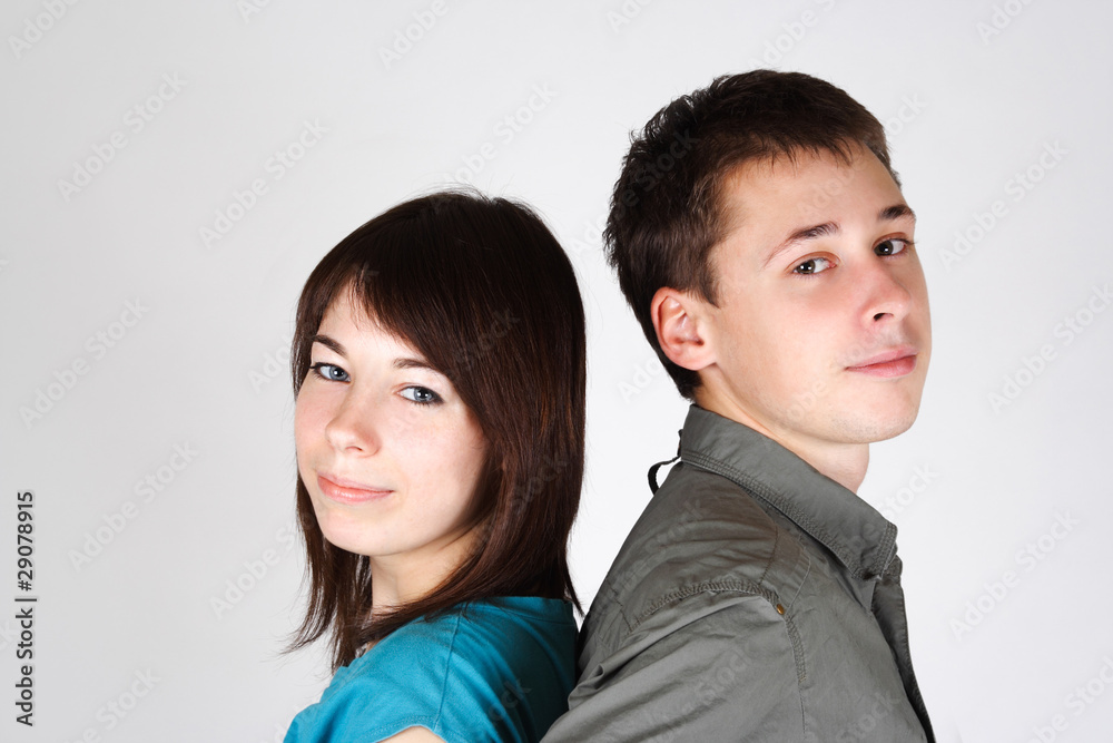 portrait of young brunette girl and man standing back to back an portrait of young brunette girl and man standing back to back an