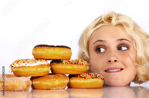 Woman stares wantingly at a donut