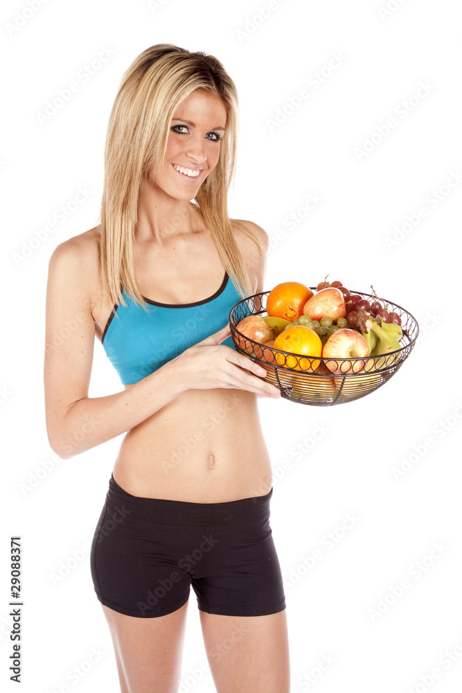 Fit woman holding fruit basket
