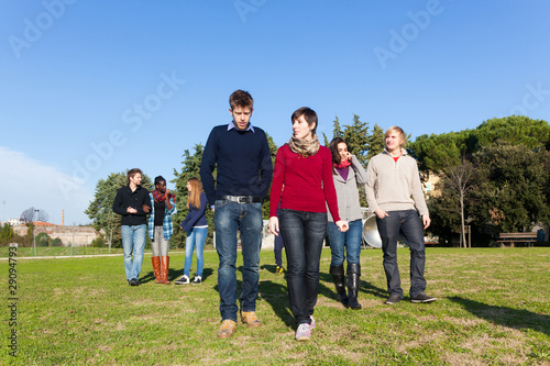College Students Walking and Talking at Park