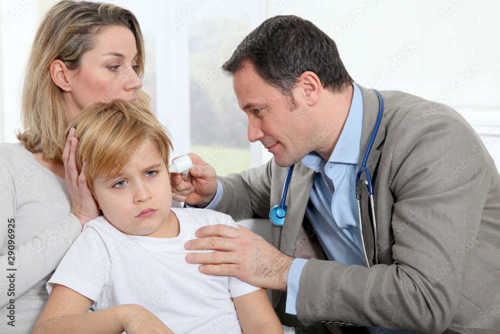 Fototapeta premium Doctor cheking little boy's ear infection