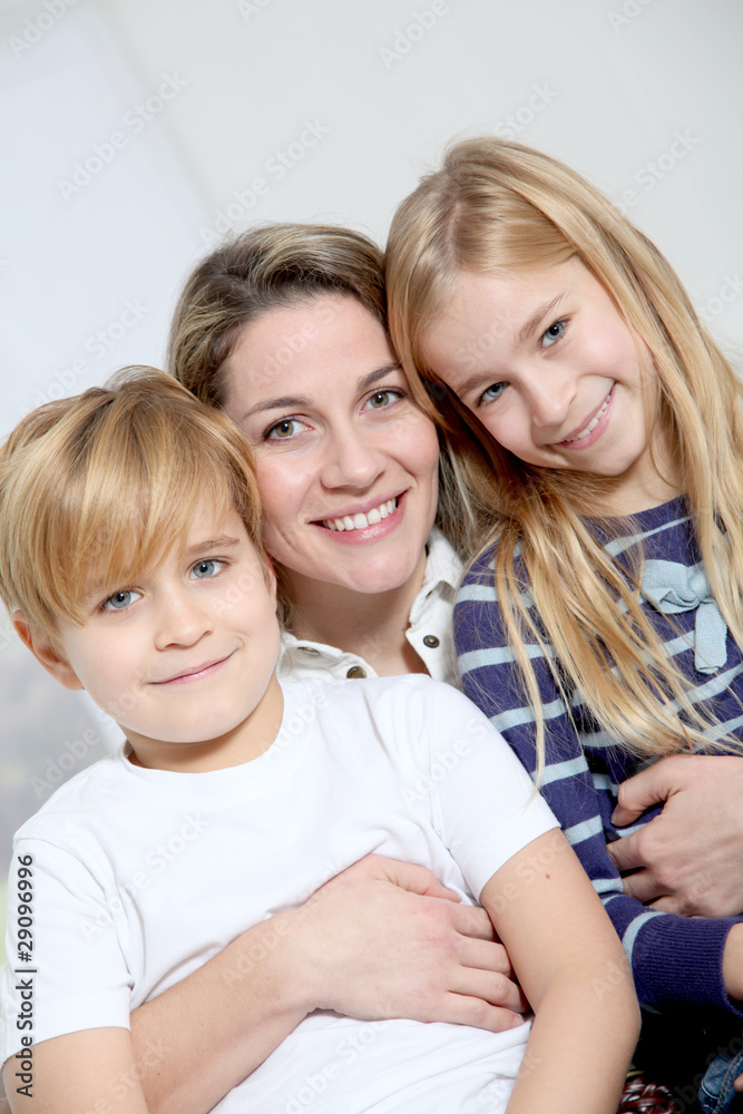portrait of happy mother with 2 blond children