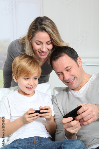 Family playing video game on smartphone