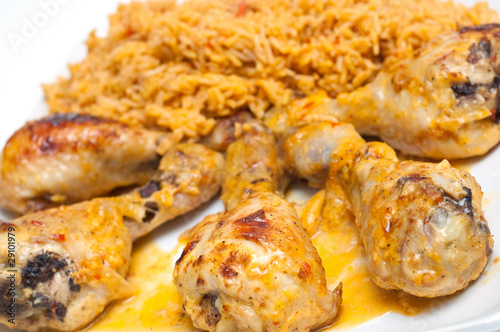 chicken drumbsticks and mexican rice on white