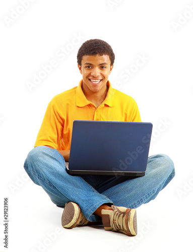 Happy young man working on a laptop, isolated