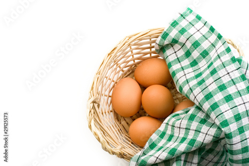 Fresh eggs in a woven basket
