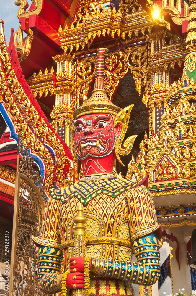 Red guardian statue at the temple