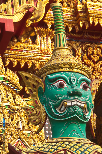 Green guardian statue at the temple