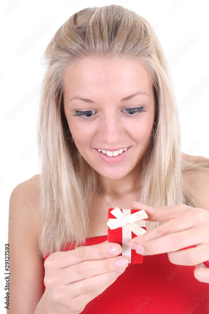 Surprised woman opening red present Surprised woman opening red present